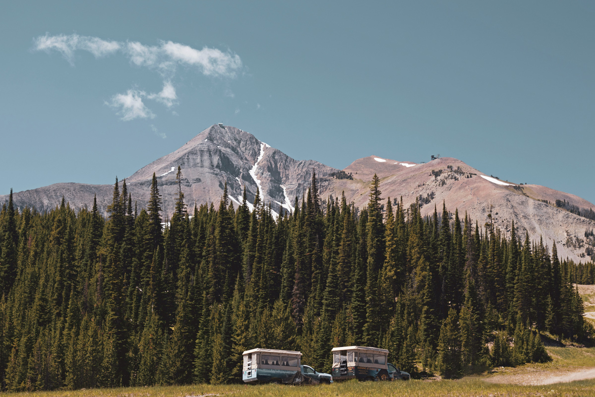 Two trucks parked on a mountain